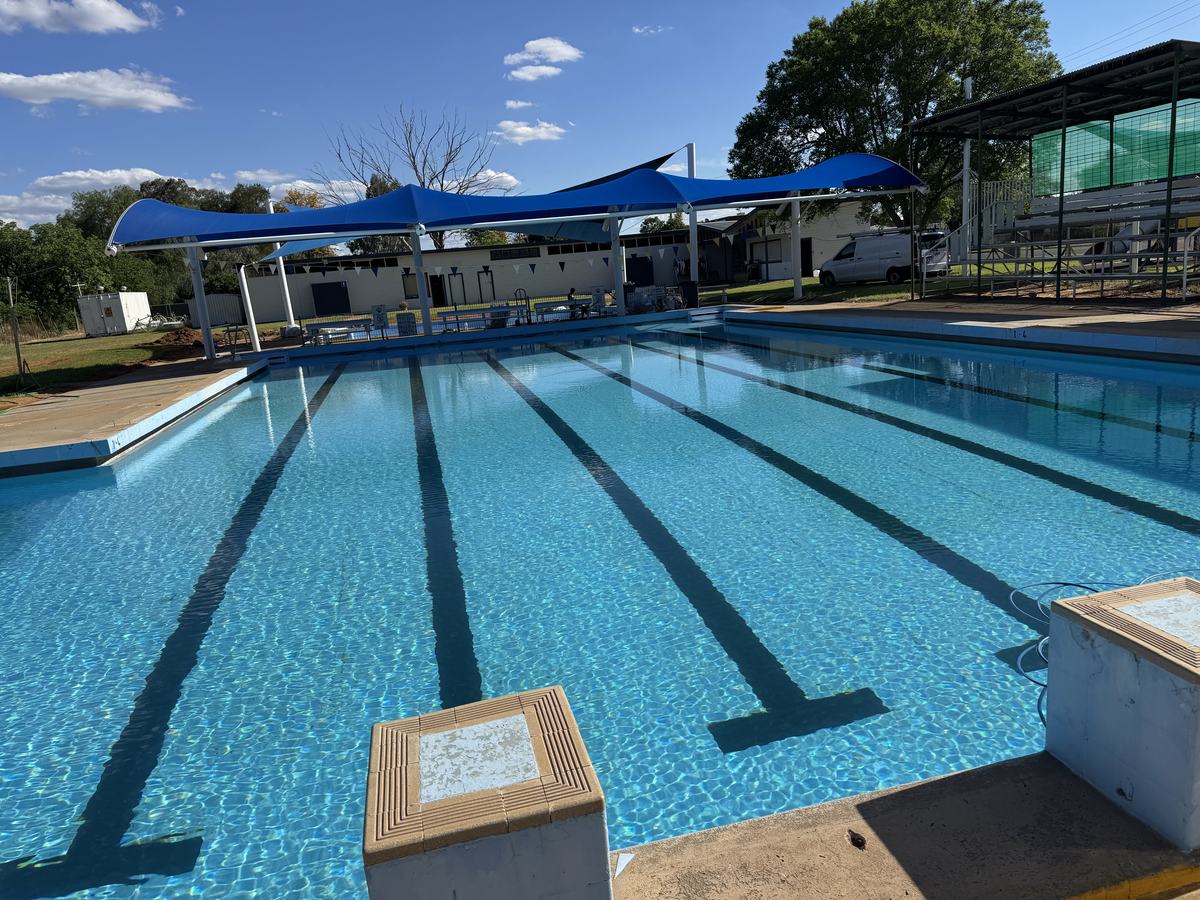 Baradine council pool after relining, full of water with shade sails