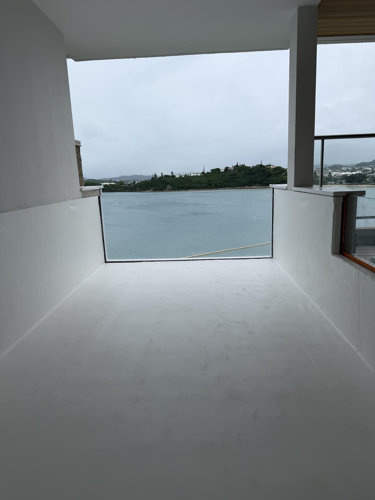 Lined plunge pool with a glass wall overlooking the water