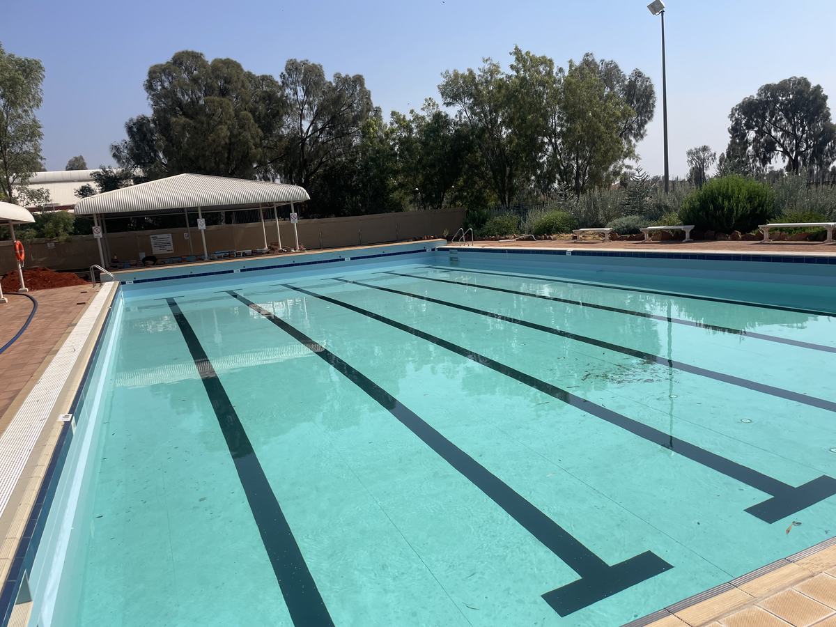 Outdoor lap pool with black lane markings in Yulara